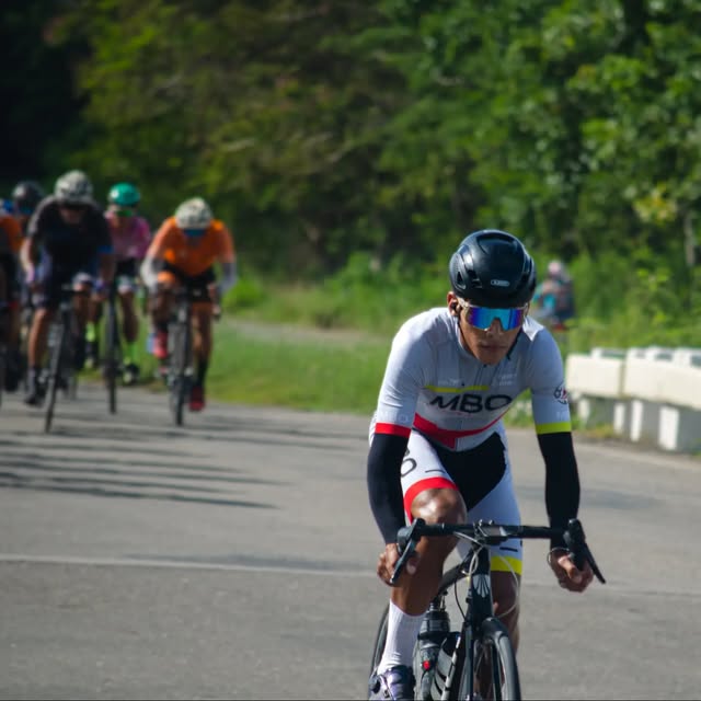 Young rider in white MBO kit leading a group