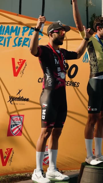 Rider in MBO kit on the podium at a Miami crit series